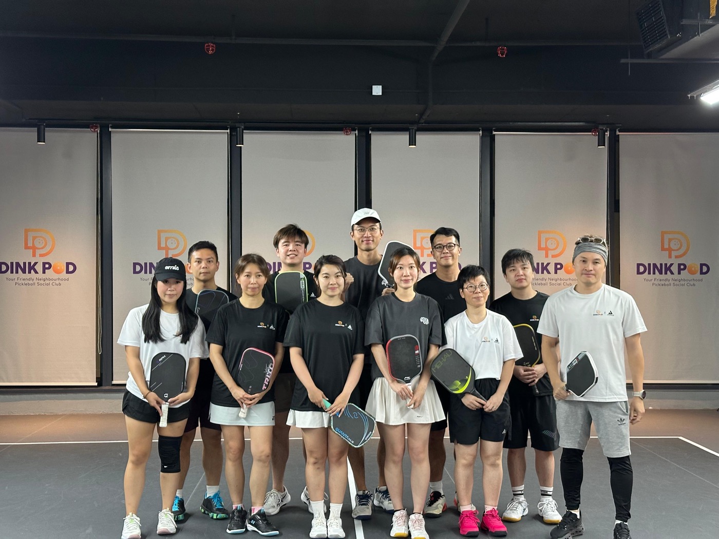 Group of players holding paddles at Dink Pod