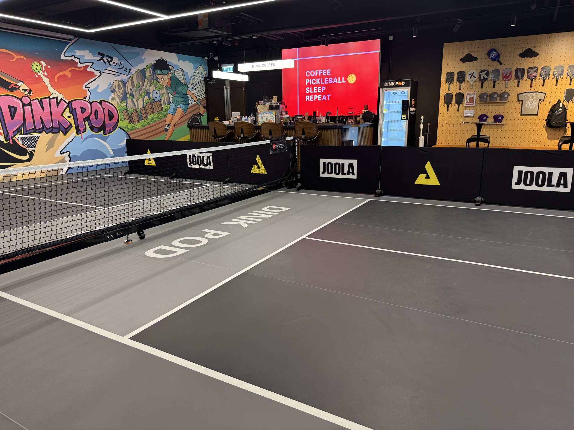 Dink Pod indoor pickleball court with mural, pro shop and coffee bar